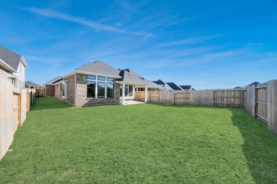 Exterior details and patio area of a home in Sunterra: Premier Collection, Katy (Image 5).