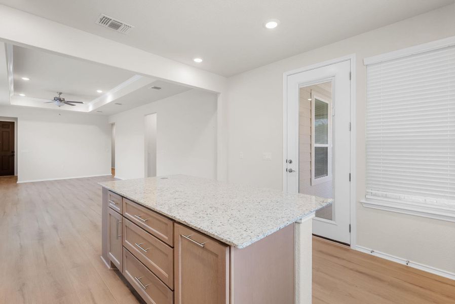 A well-appointed kitchen island with ample counter space anchors this open living area. A well-appointed kitchen island with ample counter space anchors this open living area.