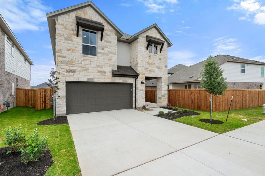 Front exterior of a new home in Heritage, Dripping Springs, TX, highlighting curb appeal (Image 21).