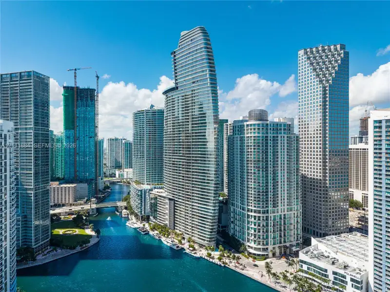 Urban waterfront high-rise featuring floor-to-ceiling glass facades, private balconies, and direct water access Urban waterfront high-rise featuring floor-to-ceiling glass facades, private balconies, and direct water access