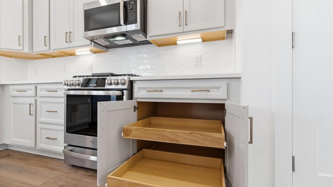 Notable kitchen space with elegant fixtures and plenty of space for entertaining and storage located at the Foxbank community