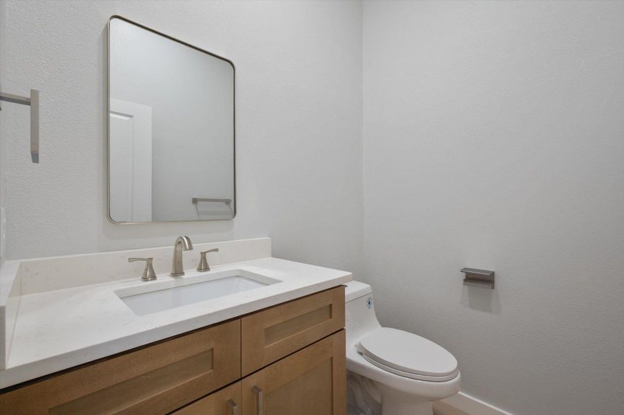 A well-appointed powder room features a sleek vanity and modern fixtures.