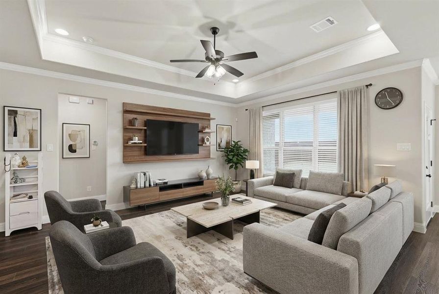 VIRTUALLY STAGED Living room featuring dark wood-style flooring, crown molding, a ceiling fan, and a tray ceiling