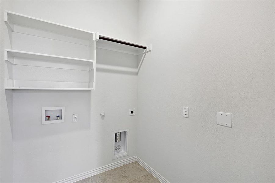 Laundry room featuring hookup for a washing machine, hookup for a gas dryer, light tile patterned floors, and electric dryer hookup