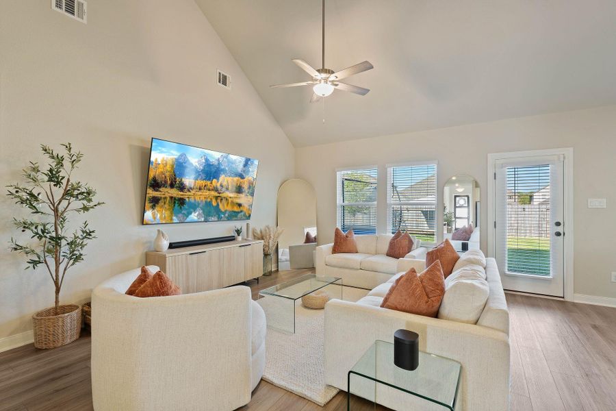 Spacious living room with high ceilings, natural light, open to kitchen and dining room. Spacious living room with high ceilings, natural light, open to kitchen and dining room.