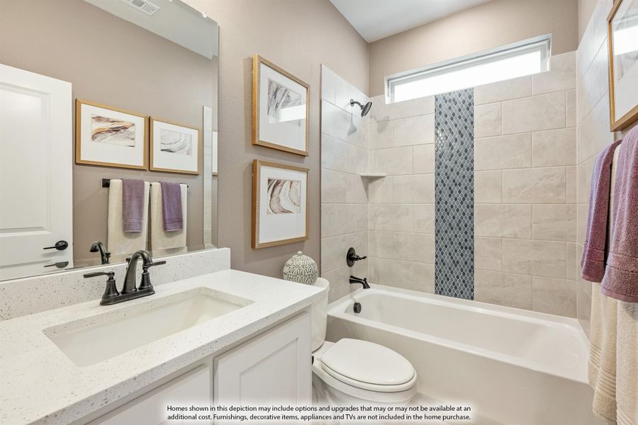 Bathroom with white quartz vanity, tub-shower combo with tile surround, and decorative mosaic accent strip. Bathroom with white quartz vanity, tub-shower combo with tile surround, and decorative mosaic accent strip.