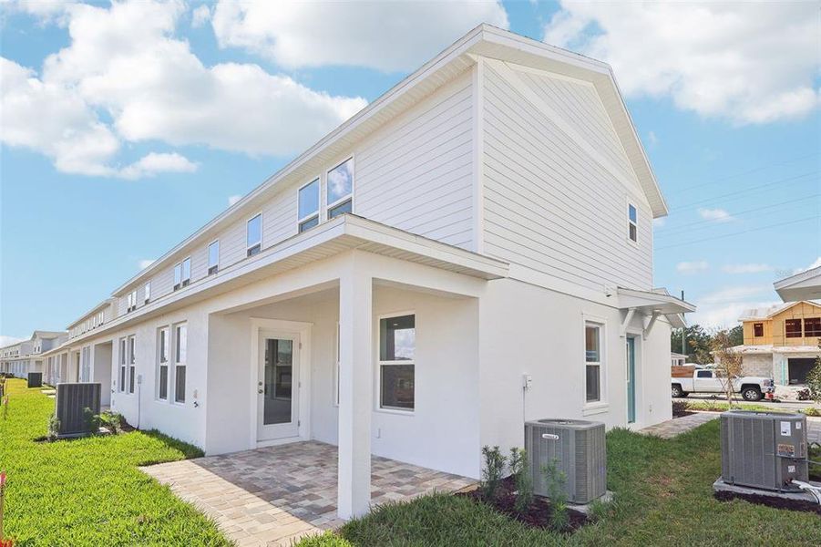 Exterior details and patio area of a home in Cyrene at Harmony, St. Cloud (Image 20).