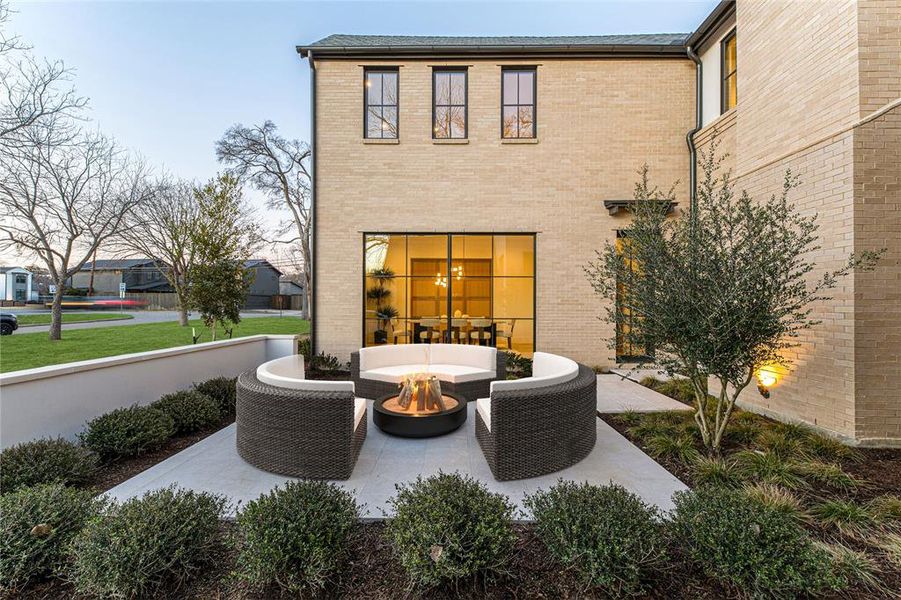 Rear view of house featuring a patio and an outdoor living space with a fire pit