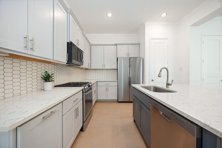 Designer details meet everyday ease. From the subway tile backsplash to the premium stainless steel appliances, this kitchen is built for cooking, gathering, and showing off.