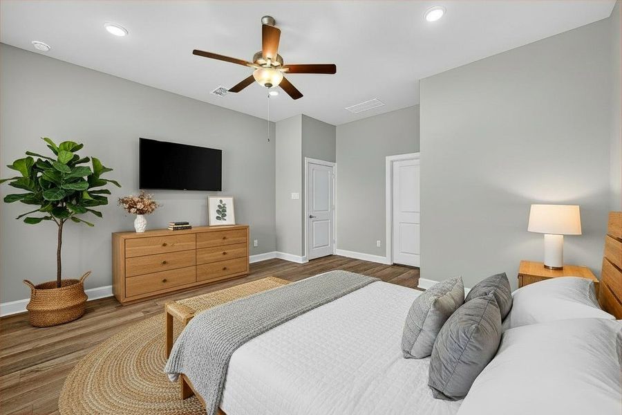 Experience the elegance of this virtually staged primary bedroom, featuring a modern design with warm wood accents and a serene color palette. Perfectly arranged for comfort and style.
