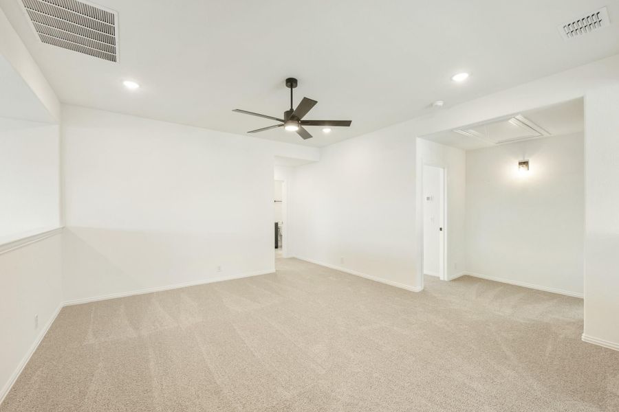 Empty room with beige carpet, white walls, ceiling fan, and recessed lighting