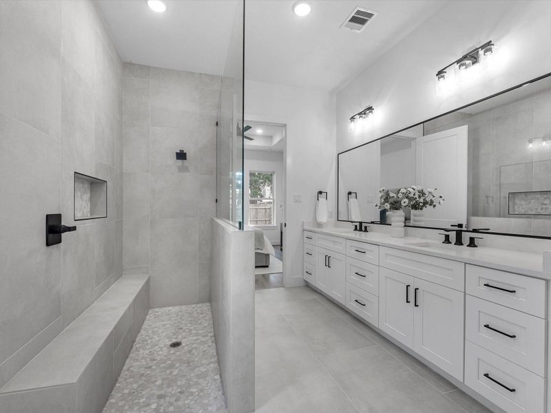 No space shortage in this walk-in shower with extended bench, in-set shelf, and frameless glass divide! No space shortage in this walk-in shower with extended bench, in-set shelf, and frameless glass divide!