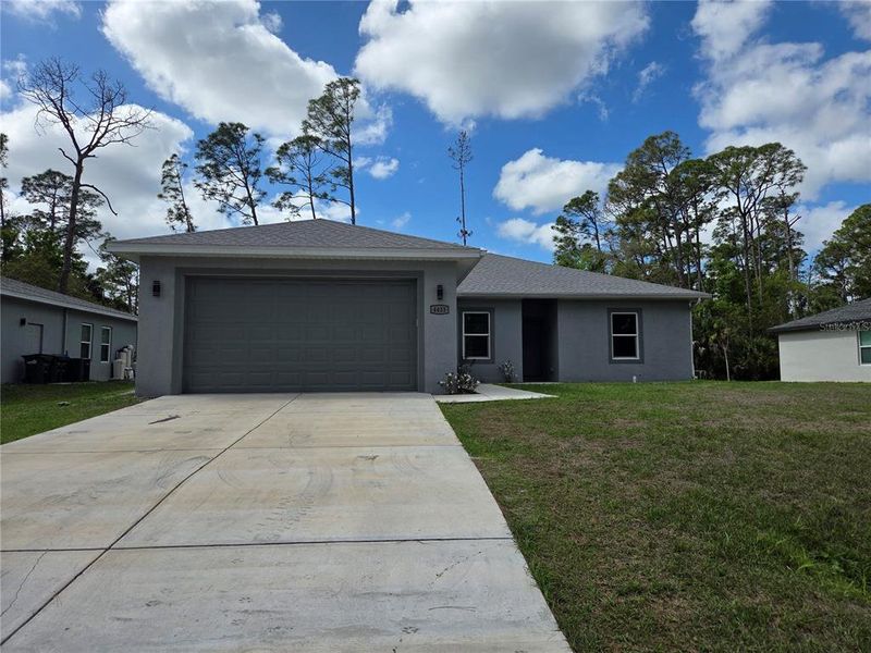 Front exterior of a new home in , North Port, FL, highlighting curb appeal (Image 1). Front exterior of a new home in , North Port, FL, highlighting curb appeal (Image 1).