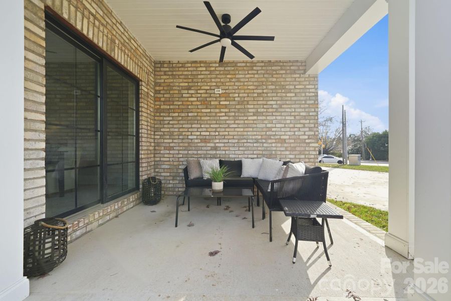 Covered porch seating with modern ceiling fan — the ideal spot for relaxing or entertaining. Covered porch seating with modern ceiling fan — the ideal spot for relaxing or entertaining.