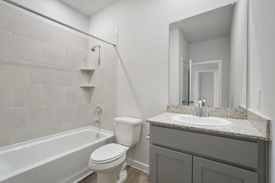 A bathroom with a tub sink and toilet. A bathroom with a tub sink and toilet.