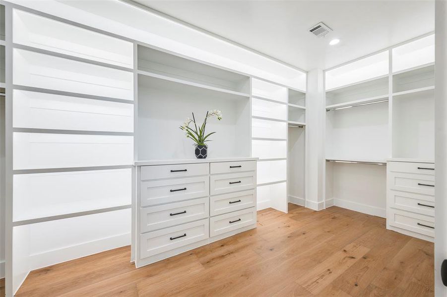 Spacious closet featuring light wood finished floors Spacious closet featuring light wood finished floors