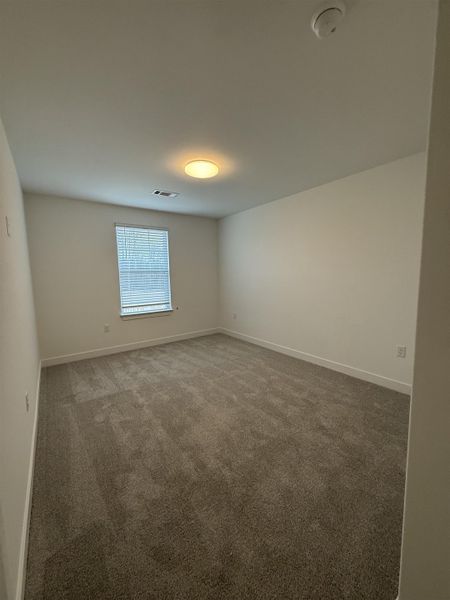 Carpeted spare room with baseboards