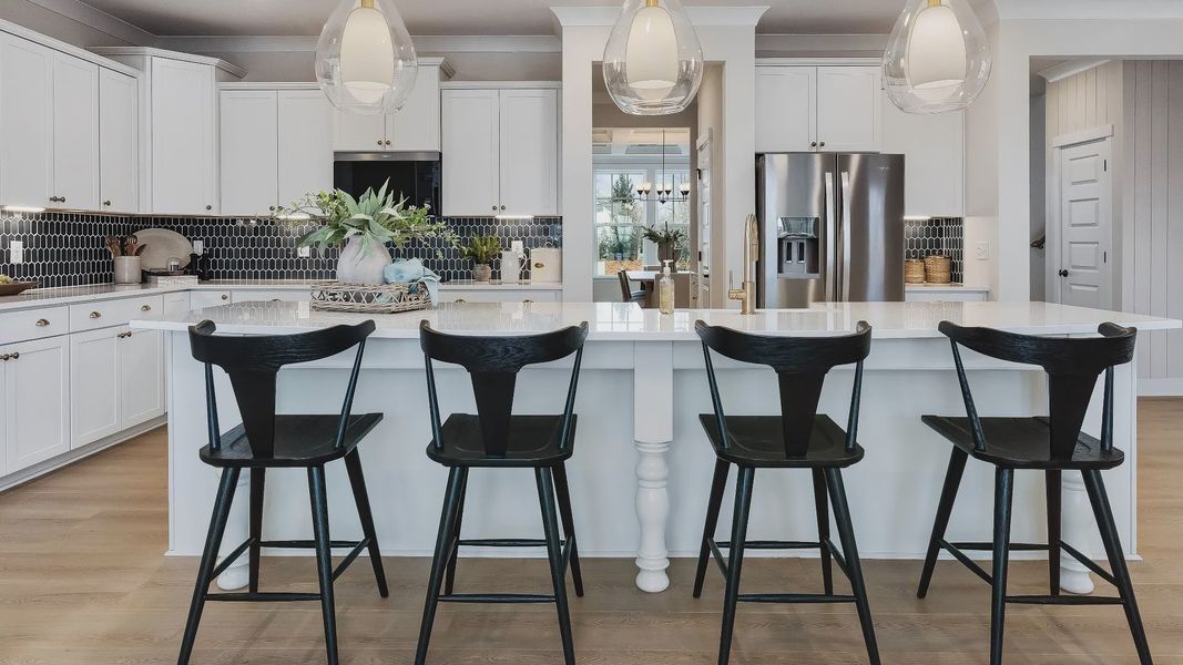 Stonefield home plan open concept kitchen with massive island and abundant cabinetry overlooking the family room/breakfast Stonefield home plan open concept kitchen with massive island and abundant cabinetry overlooking the family room/breakfast