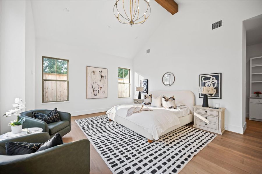 Bright and inviting primary suite featuring high ceilings with exposed wooden beams. Bright and inviting primary suite featuring high ceilings with exposed wooden beams.