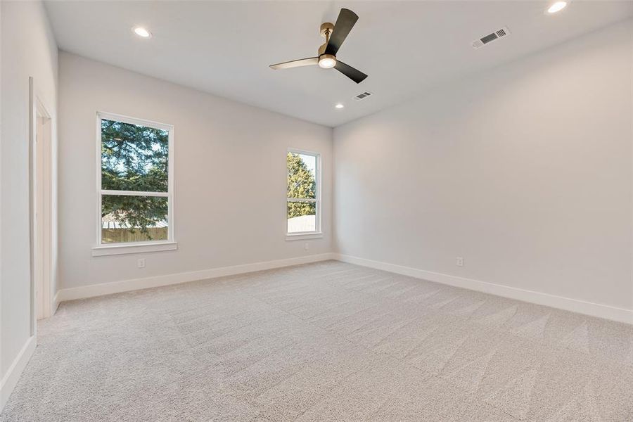 Unfurnished room with light colored carpet, recessed lighting, and a ceiling fan Unfurnished room with light colored carpet, recessed lighting, and a ceiling fan