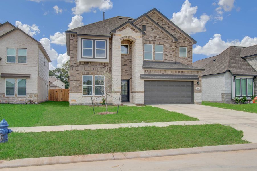Front exterior of a new home in Harmony Cove, Humble, TX, highlighting curb appeal (Image 23).
