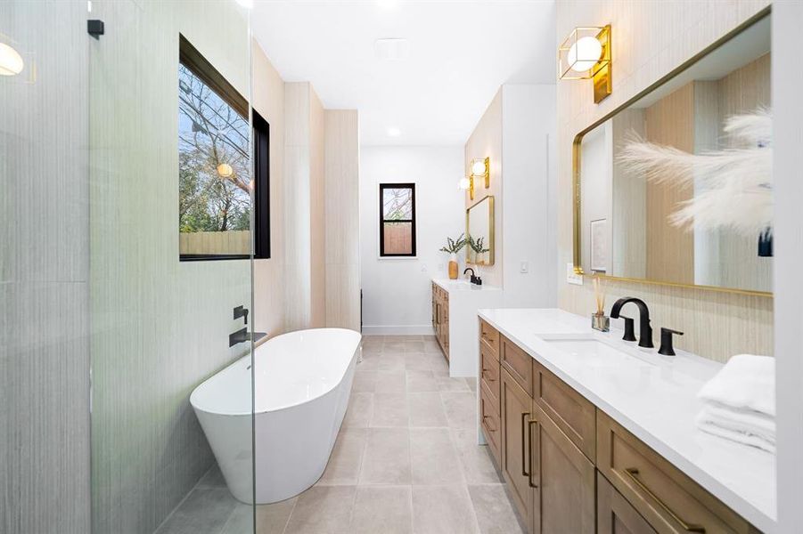 The separate vanities, stylish fixtures, and spacious countertops cater to a shared space