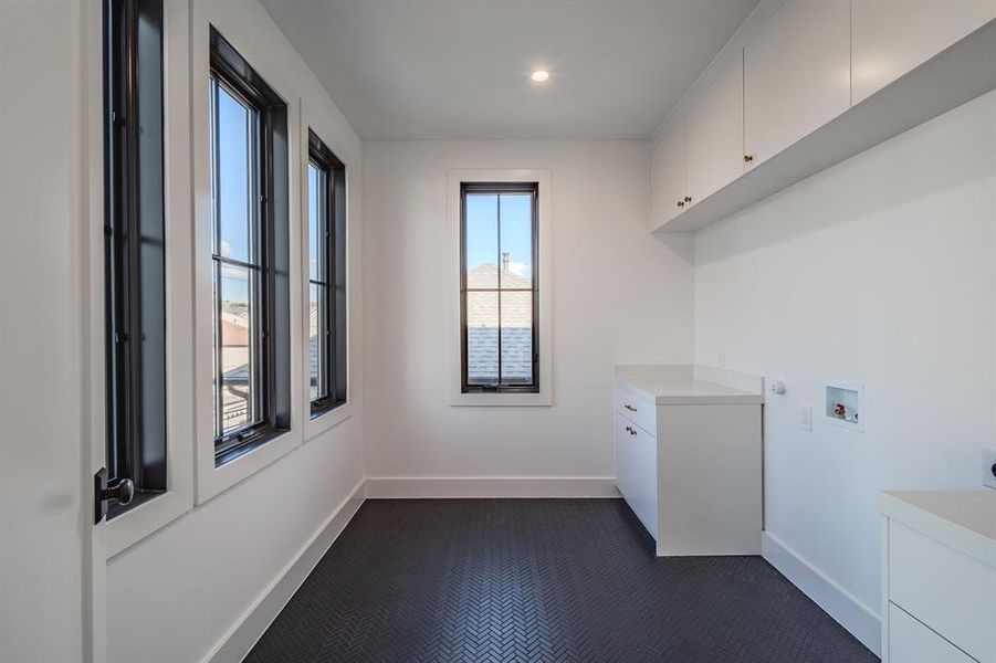 Washroom with washer hookup, cabinet space, electric dryer hookup, and recessed lighting Washroom with washer hookup, cabinet space, electric dryer hookup, and recessed lighting