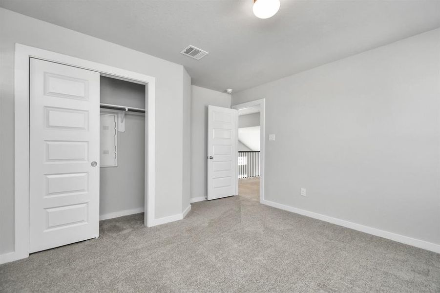 Generously sized secondary bedrooms featuring spacious closets, soft and inviting carpeting underfoot, large windows allowing plenty of natural light, and the added touch of privacy blinds for your personal retreat. Sample photo of completed home with similar floor plan. As-built interior colors and selections may vary.