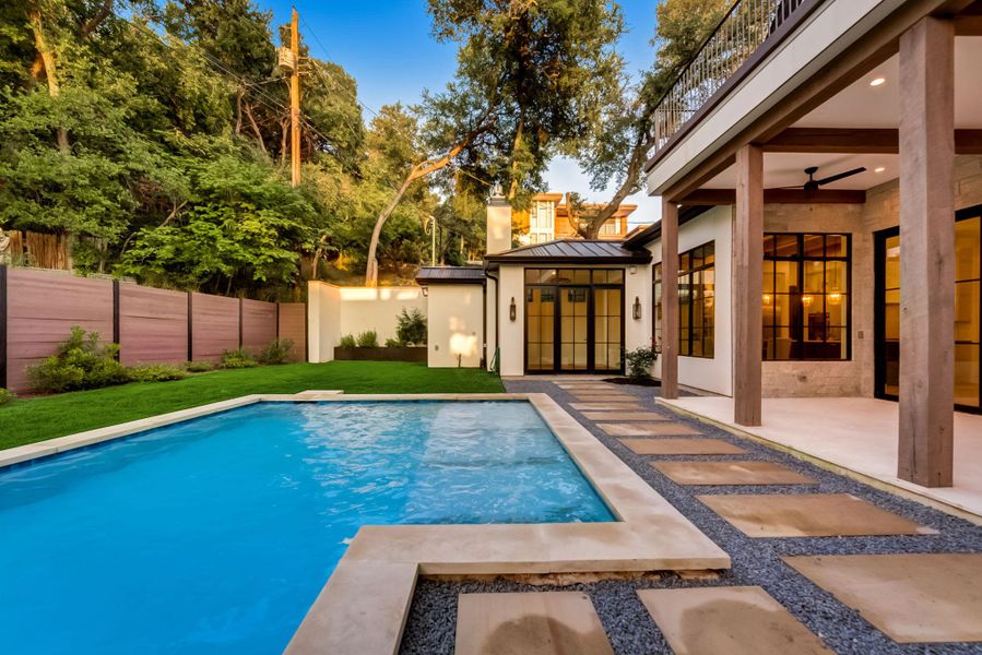 View of swimming pool with a patio area, a yard, fence, and a fenced in pool