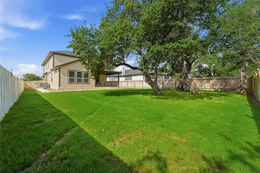A spacious, verdant yard with mature shade trees, offering ample room for recreation. A spacious, verdant yard with mature shade trees, offering ample room for recreation.