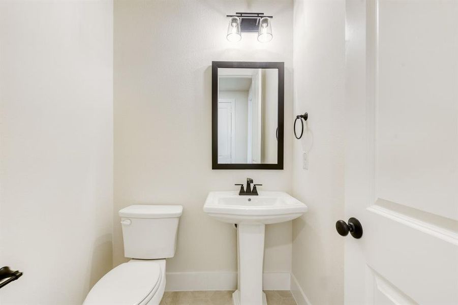 Bathroom featuring toilet and baseboards