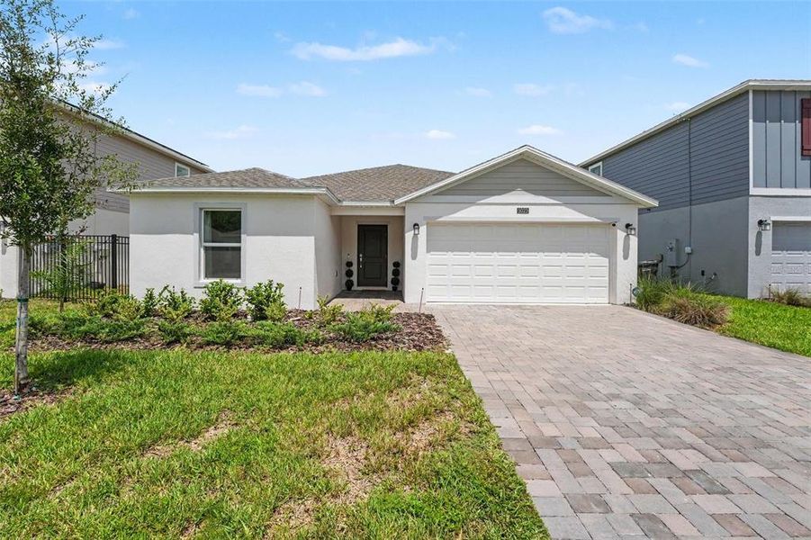 Front exterior of a new home in Providence, Davenport, FL, highlighting curb appeal (Image 1). Front exterior of a new home in Providence, Davenport, FL, highlighting curb appeal (Image 1).