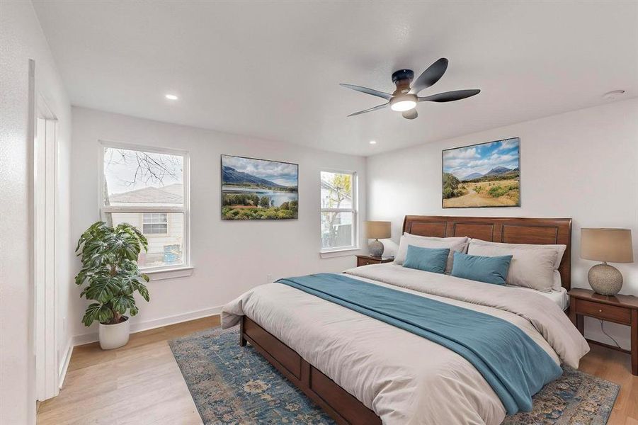 Bedroom featuring ceiling fan and light wood-type flooring