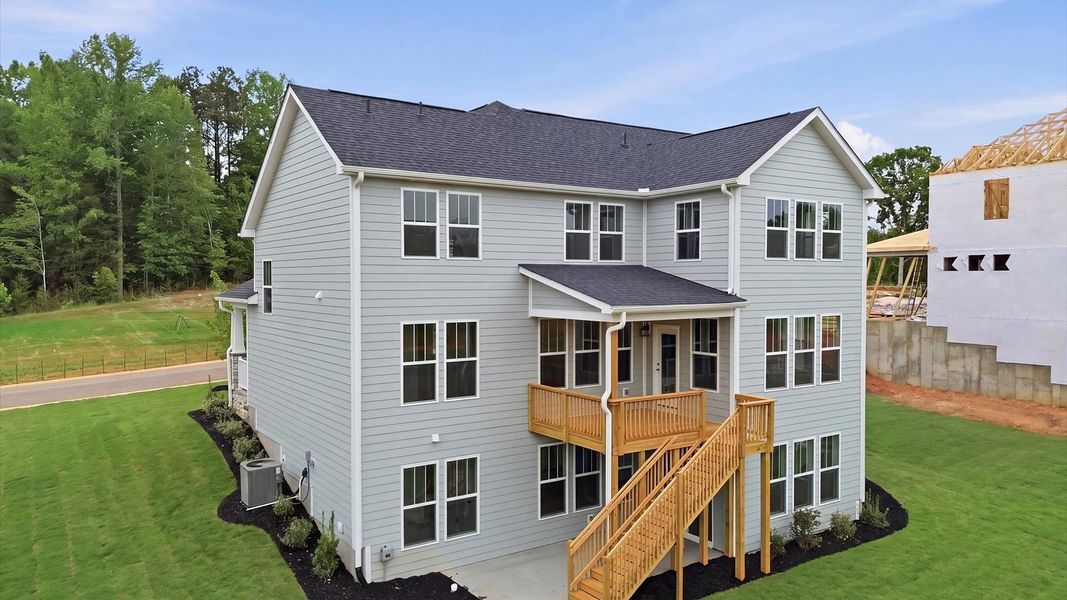 Superior curb appeal continues to the back with refined, covered outdoor living spaces