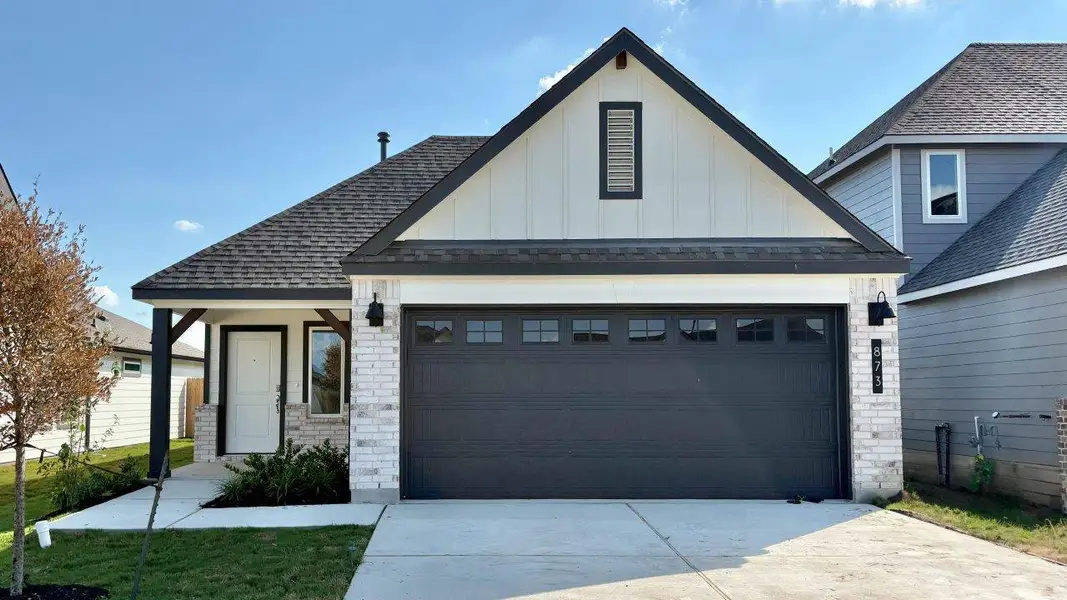 Front exterior of a new home in Midtown Reserve, College Station, TX, highlighting curb appeal (Image 1). Front exterior of a new home in Midtown Reserve, College Station, TX, highlighting curb appeal (Image 1).