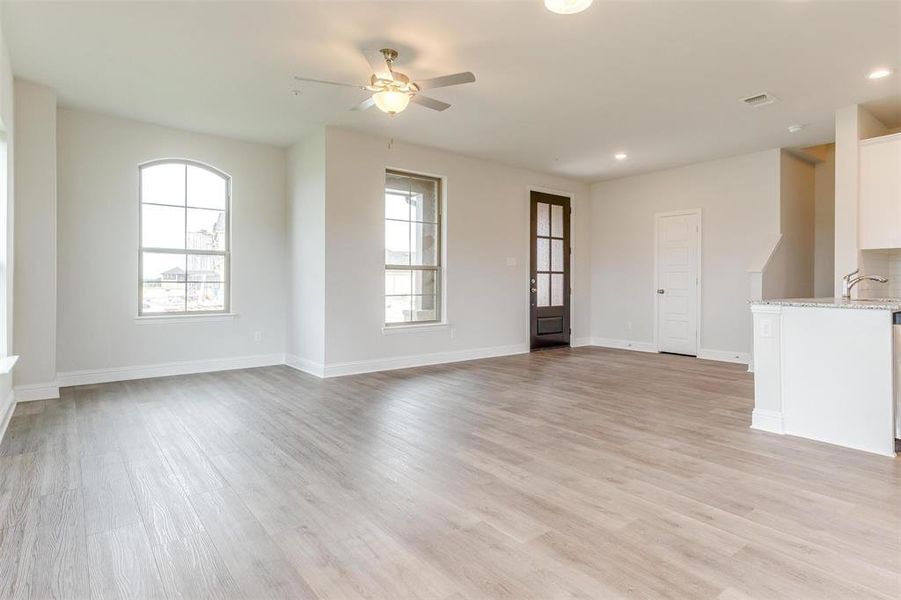 Unfurnished living room with recessed lighting, light wood finished floors, and a ceiling fan