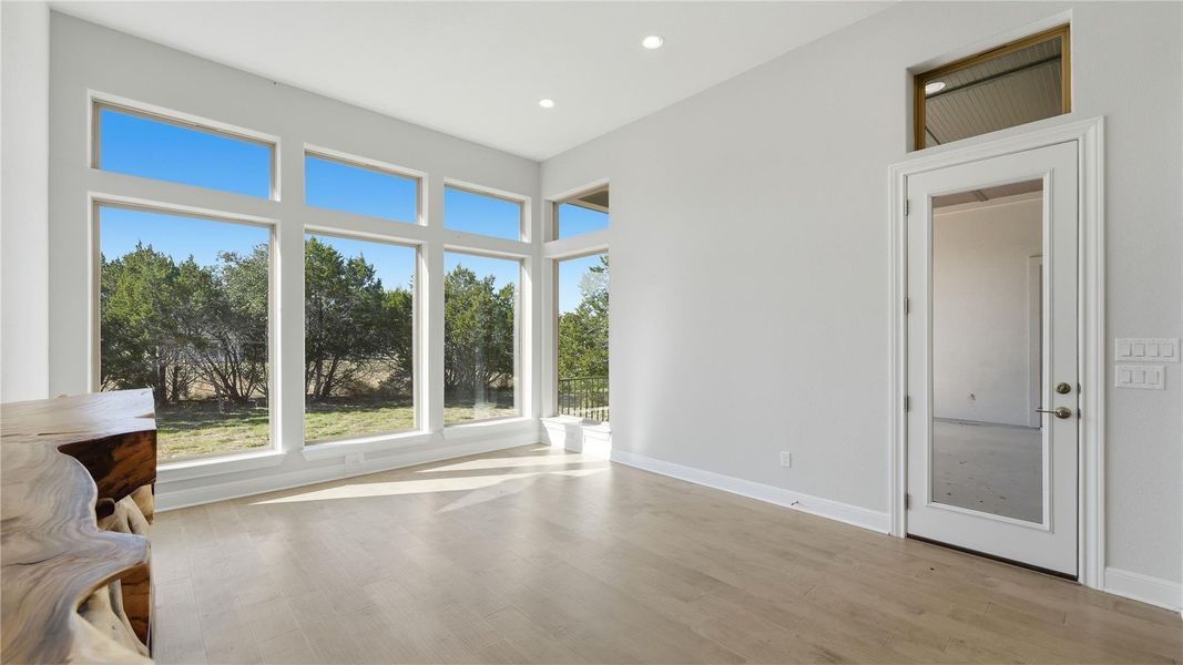 Unfurnished living room featuring light wood finished floors and recessed lighting Unfurnished living room featuring light wood finished floors and recessed lighting