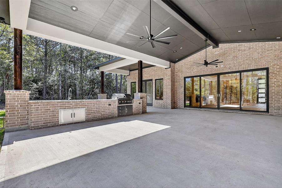 Covered patio with seamless indoor-outdoor flow from both the living area and the game room.