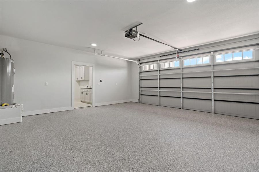 Garage with electric water heater and a garage door opener