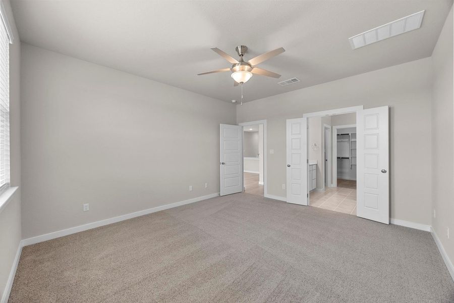 Soft carpet and a ceiling fan create a peaceful, comfortable bedroom retreat. Soft carpet and a ceiling fan create a peaceful, comfortable bedroom retreat.