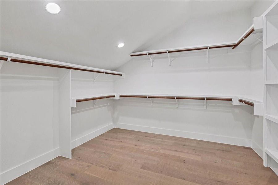 Holy closet space! This expertly designed closest maximizes space with functional shelving and hanging space