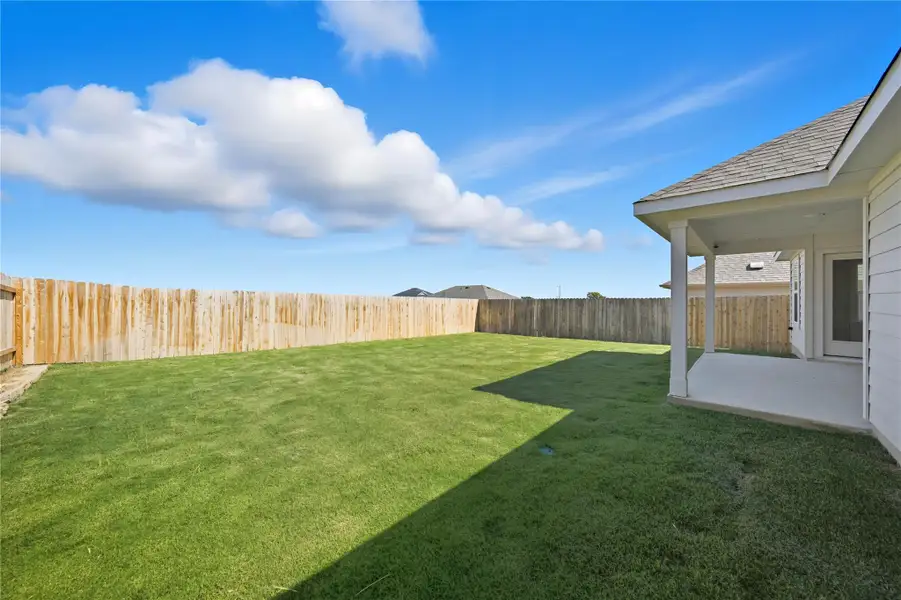 Fenced backyard featuring a patio