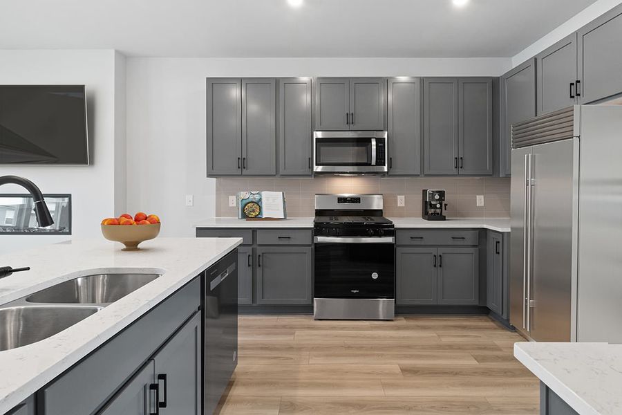 A kitchen with black cabinets. A kitchen with black cabinets.