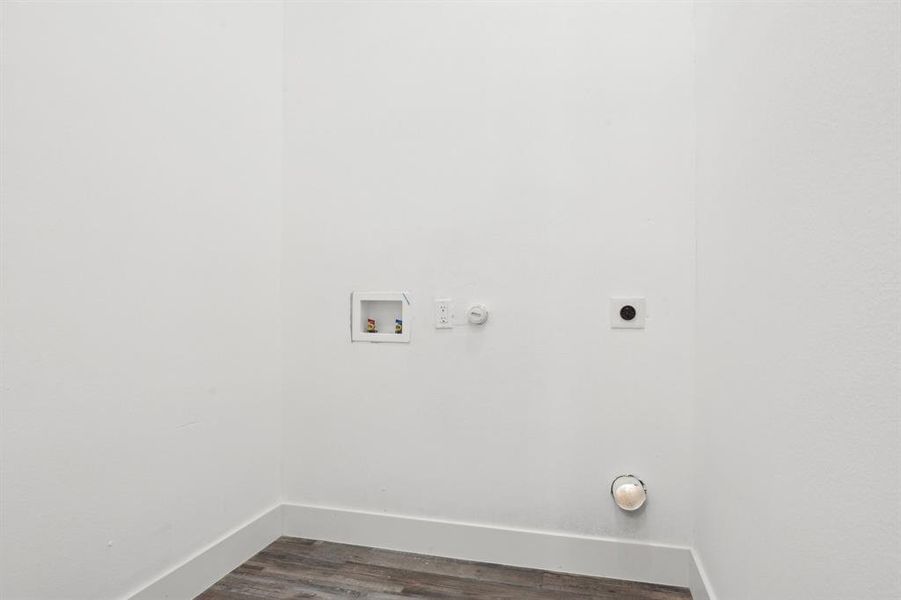 Washroom featuring hookup for a washing machine, laundry area, dark wood-type flooring, baseboards, and electric dryer hookup