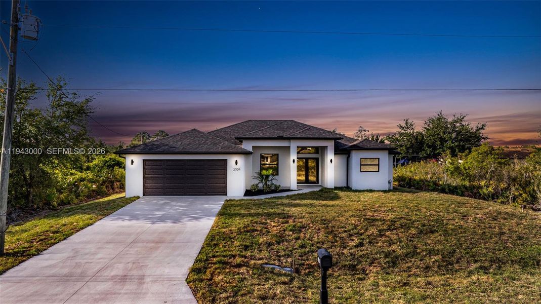 Front exterior of a new home in , Lehigh Acres, FL, highlighting curb appeal (Image 21).