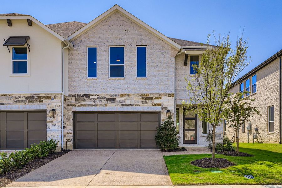 Front exterior of a new home in Castle Hills Northpointe - Townhomes, Lewisville, TX, highlighting curb appeal (Image 1).