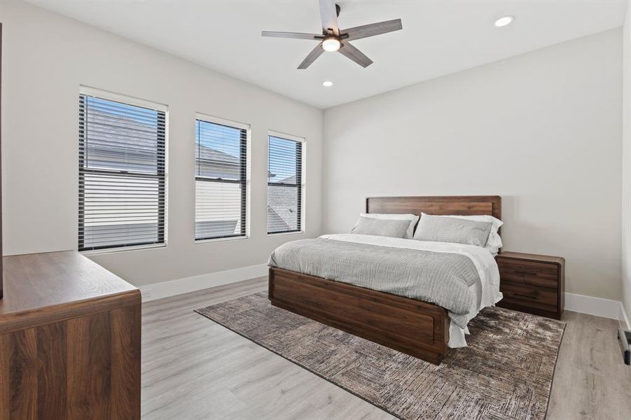 Bedroom with ceiling fan, light wood-type flooring, and recessed lighting