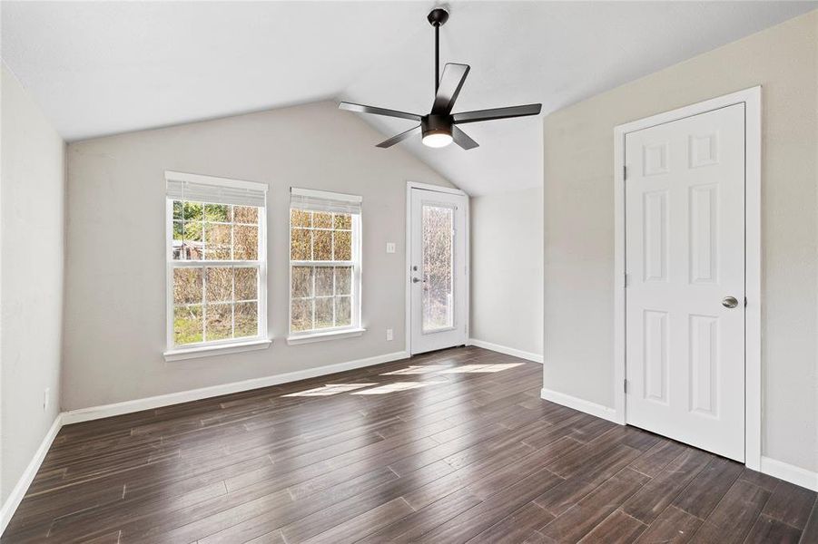 bedroom featuring vaulted ceiling, ceiling fan, and dark wood-style floors