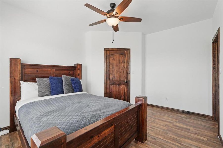 Bedroom with dark wood-type flooring and ceiling fan Bedroom with dark wood-type flooring and ceiling fan