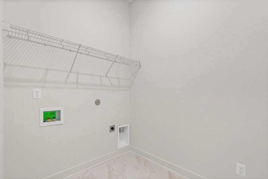 Laundry room featuring washer hookup, electric dryer hookup, and light marble finish floors